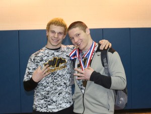 Luke Landefeld, Zach Smith pose with medals.