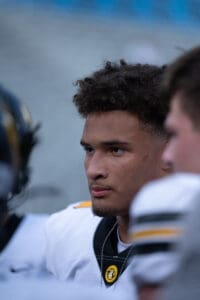 Focused football player in uniform on the field during a game.