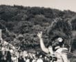 Football player celebrating a touchdown on the field, fans cheering in the background.