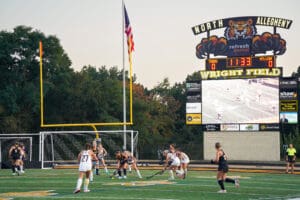 Field hockey game at Wright Field, players in action, scoreboard displaying 0-0, North Allegheny Tigers vs MTLebo.