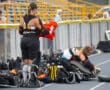 Field hockey players preparing gear on the sideline before a match.