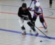Inline hockey players in action on a rink, competing for the puck with intensity and skill.