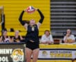 Volleyball player in action, setting the ball during a match for the North Allegheny Tigers team.