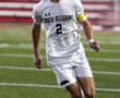 Soccer player in white North Allegheny uniform dribbles on field during a match.