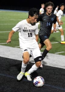 Soccer match action with players from North Allegheny and SV competing for the ball on the field.