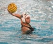 Water polo player in action, preparing to throw the ball.