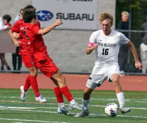 Soccer players in action on a field, North Allegheny and opponent, intense match atmosphere.