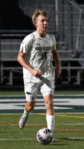 Soccer player in action, wearing a North Allegheny uniform, dribbling a ball on the field during a match.