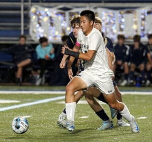 Soccer players in action during a game, focused on ball control and teamwork on the field.