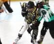 Two inline hockey players in action, battling for the puck on a rink.