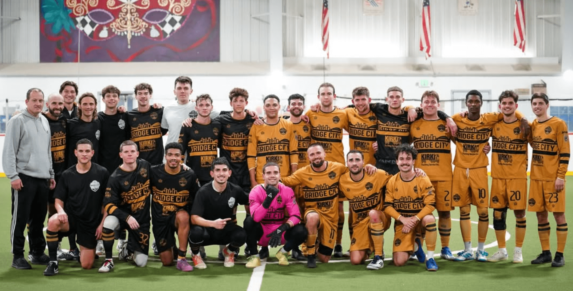 Indoor soccer team posing in golden jerseys with Bridge City logo; group photo with coach, standing and kneeling players.
