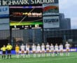 Girls' soccer team lineup at Highmark Stadium with scoreboard displaying 0-0 halftime score.