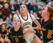Girls basketball game action between Tigers and Lincoln Park, players intensely watching the ball.