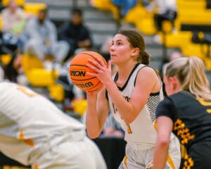 Basketball player focused on free throw during intense game.
