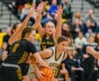 Girls' high school basketball game action with players competing for the ball on the court.