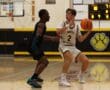 High school basketball game action, North Allegheny player guarding opponent on court, focus on defense and strategy.