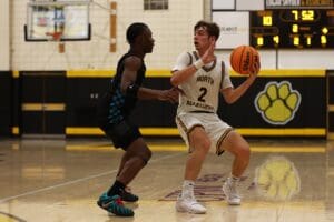 High school basketball game action, North Allegheny player guarding opponent on court, focus on defense and strategy.