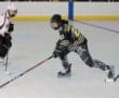 Roller hockey match action with players competing for the puck on the rink.