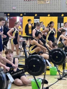 Students participating in an indoor rowing competition at Marshall Middle School gym.