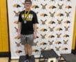 Young athlete stands proudly with a silver medal on a podium at North Allegheny event.