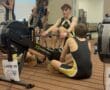 Indoor rowing team competing on ergometer machines at indoor championships.