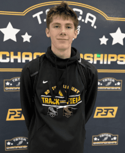 Teen athlete with medals at Track and Field Championships event backdrop.