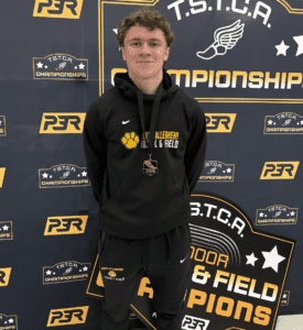 Young athlete with medal at TSTCA Indoor Track & Field Championships. North Allegheny uniform.