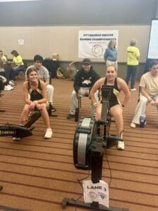 Indoor rowing competition at Pittsburgh championships, participants on erg machines ready to race, lane 3.