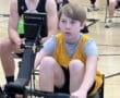 Young athletes competing in an indoor rowing event, focused and determined.