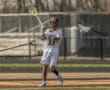 Lacrosse player in action on the field, showcasing skills with a bright green stick and focused expression.