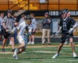 Lacrosse players in action during a game, showcasing skill and teamwork on the field.
