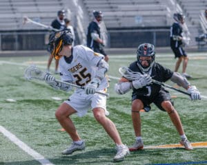 Lacrosse players in action during a game, showcasing teamwork and athleticism on the field.