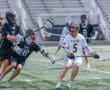 Lacrosse players in action, USC vs. Tigers, showcasing dynamic gameplay on the field.