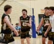 North Allegheny volleyball players celebrating a point with excitement during a match in a gymnasium.