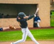 A baseball player swings at a pitch on the field, showcasing action and athleticism during a game.