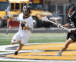 High school lacrosse players compete on the field, showcasing skill and strategy during an exciting game.