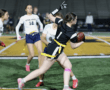 Action shot of female flag football players in a competitive match, showcasing agility and teamwork on the field.