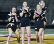 Cheerful female flag football players celebrating together on the field, showing team spirit with fun poses.