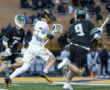 Lacrosse players in action during a game, showcasing athleticism and competition on the field.