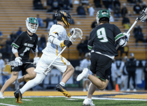 Lacrosse players in action during a game, showcasing athleticism and competition on the field.