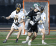 High school lacrosse players compete on the field, showcasing athleticism and teamwork during a dynamic game.