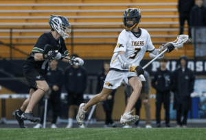 High school lacrosse players compete on the field, showcasing skill and athleticism in a dynamic match.