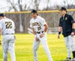 Baseball players in striped uniforms warming up on the field, showcasing teamwork and athleticism.