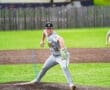 Young baseball pitcher in motion on the mound, showcasing intense focus during a game on a vibrant field.