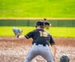 Baseball player slides into base while opposing player prepares to tag, capturing a thrilling moment on the field.