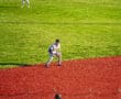 Three baseball players positioned on a vibrant field, focused on the game as they prepare for action.