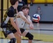 High school boys volleyball players practice, focusing on serve receive. Dynamic action shot of ball in motion.