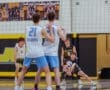 Boys' volleyball players in action during a match, focusing on teamwork and gameplay dynamics on the court.