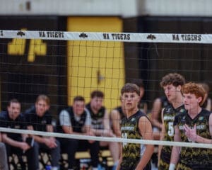 High school volleyball players from North Allegheny preparing for a match with team spirit and focus visible on their faces.