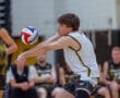 High school athlete prepares to pass a volleyball during a competitive match, showcasing skills and teamwork.